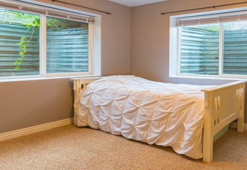 Basement sleeping area with natural light coming from windows in Columbus, OH